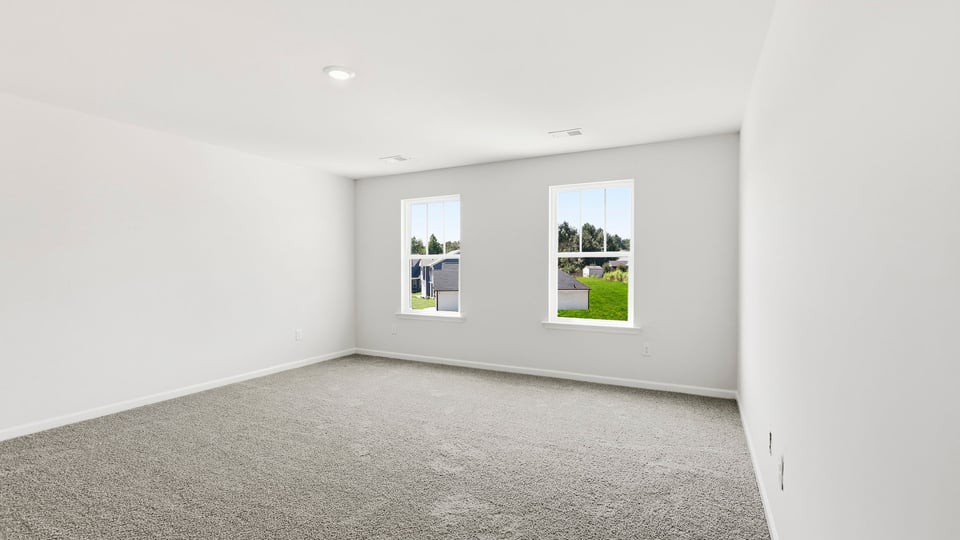 Bedroom with carpet and window.