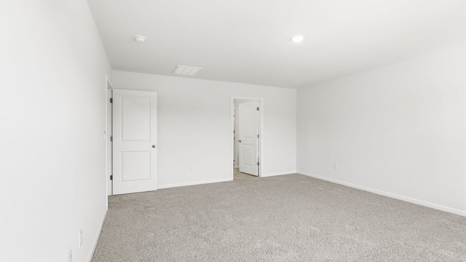 Bedroom with carpet and window.