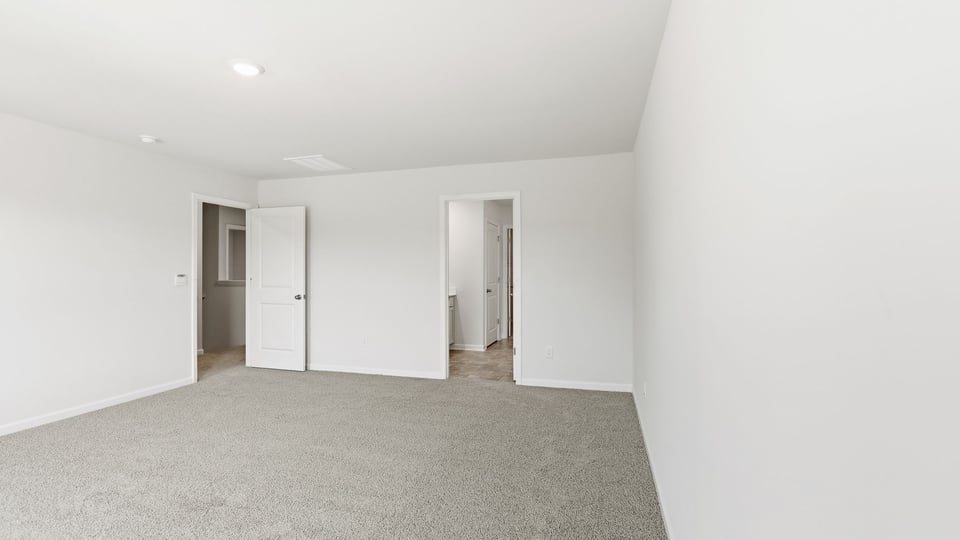 Bedroom with carpet and window.