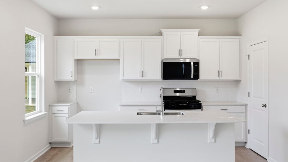 Kitchen and island with quartz countertops.
