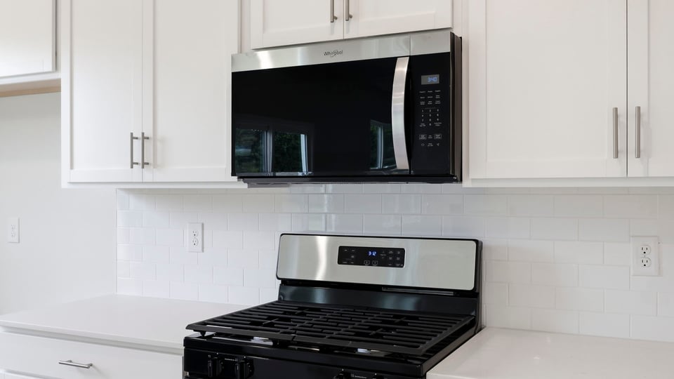 Kitchen and island with quartz countertops.