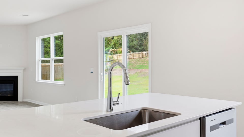 Kitchen and island with quartz countertops.