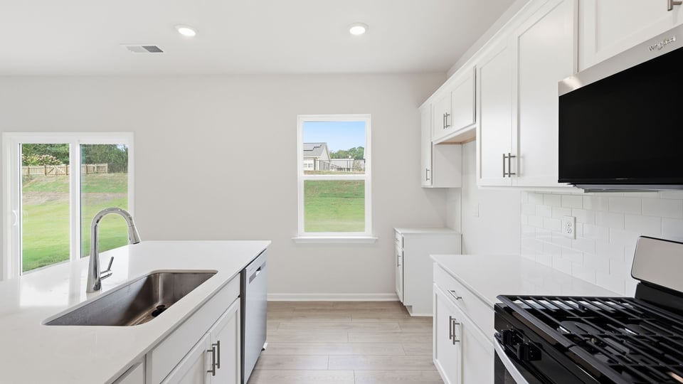 Kitchen and island with quartz countertops.