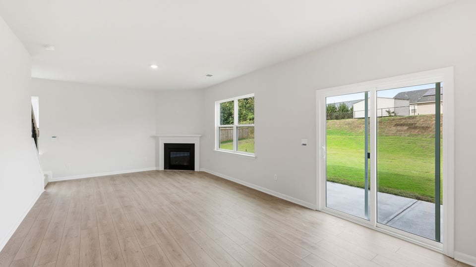 Living room with fireplace and windows.