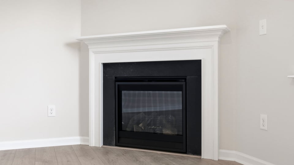 Living room with fireplace and windows.