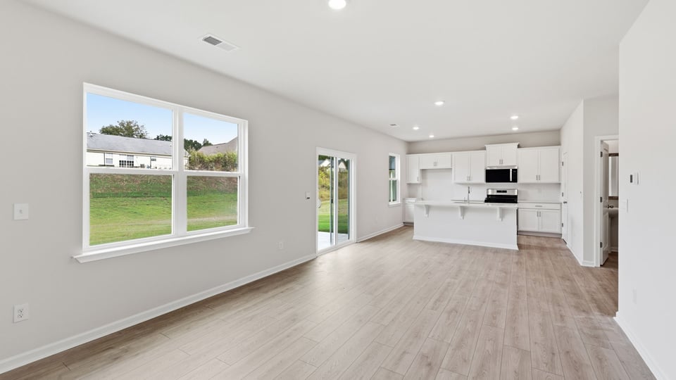 Living room with fireplace and windows.
