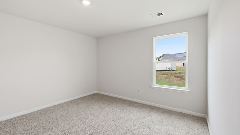 Bedroom with carpet and window.