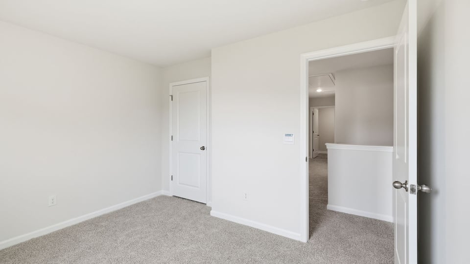 Bedroom with carpet and window.