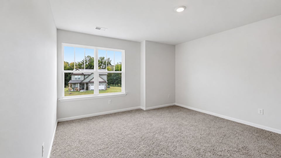 Bedroom with carpet and window.