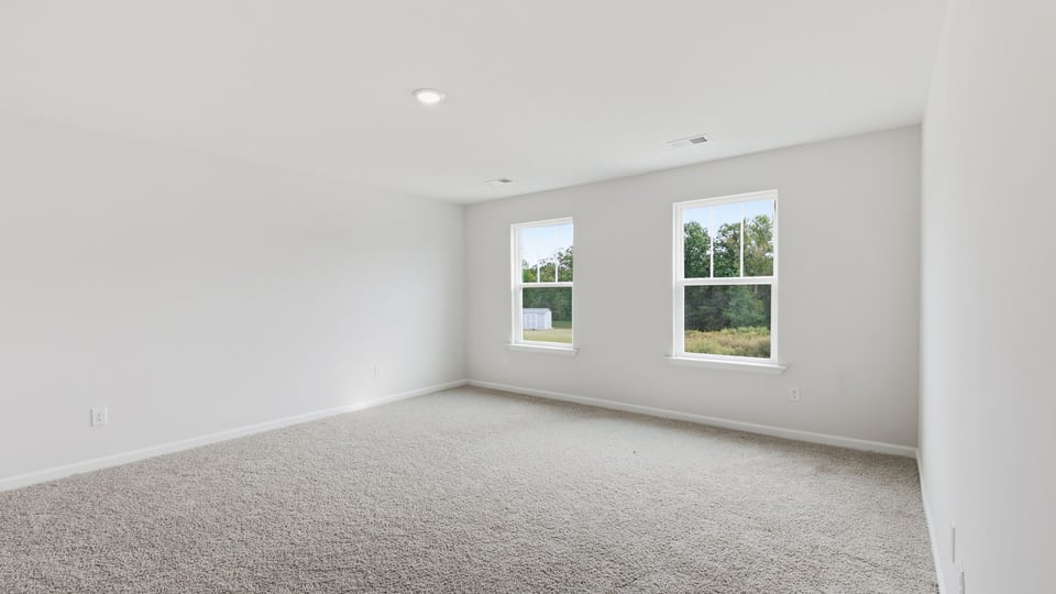Bedroom with carpet and window.