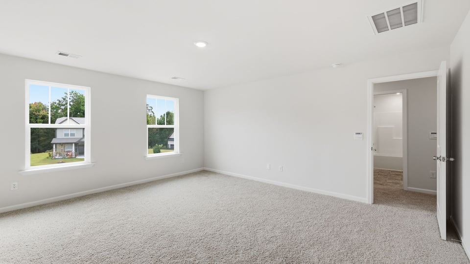 Bedroom with carpet and window.