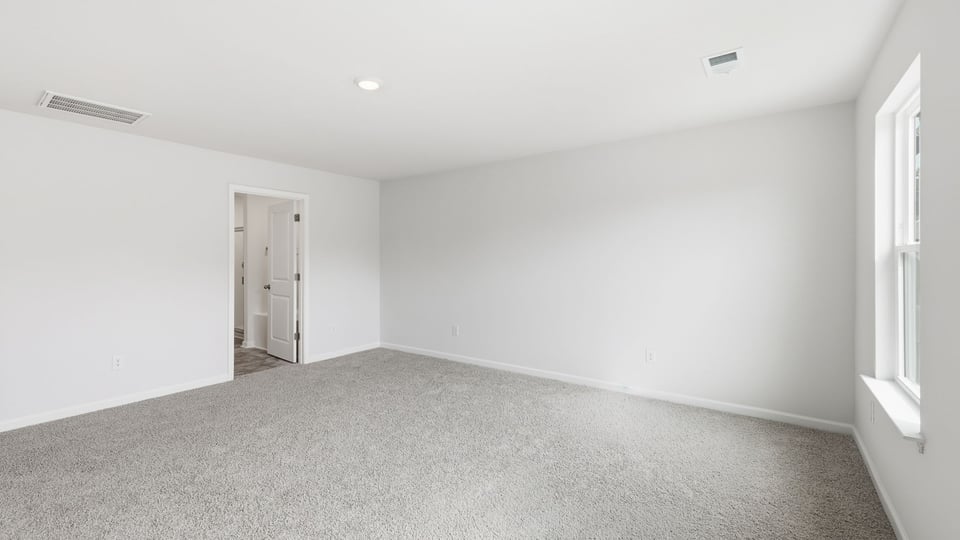 Bedroom with carpet and window.