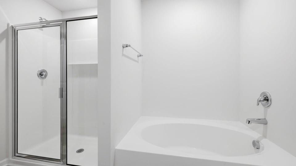 Bathroom with walk in closet and bathtub.