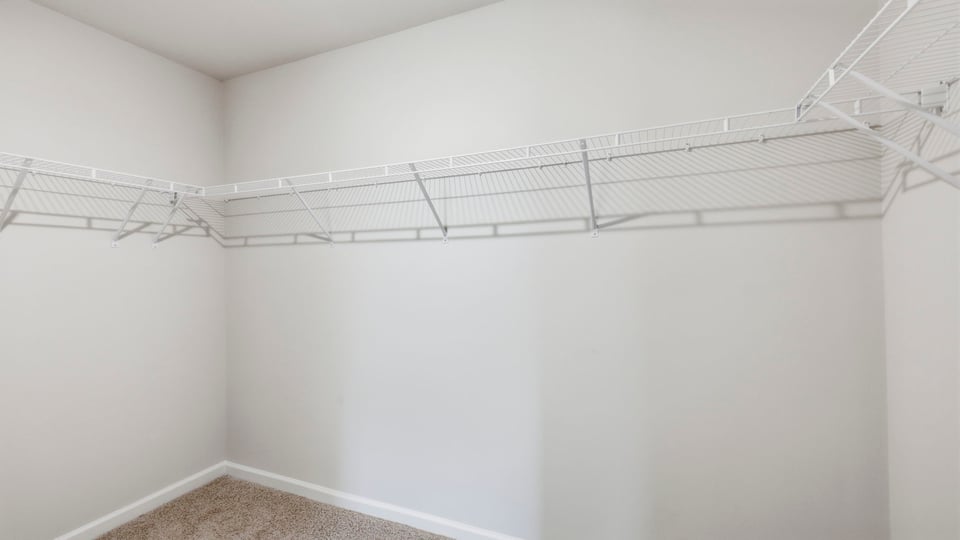 Closet with hanging storage racks.