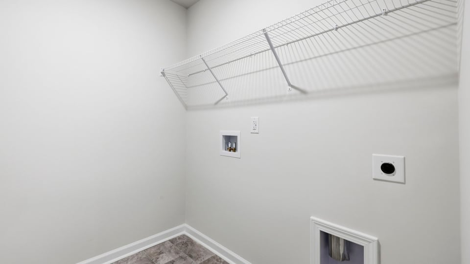 Laundry room with hanging storage racks.