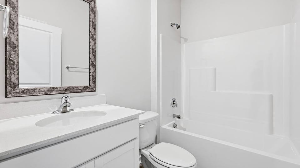 Bathroom with single vanity sink and bathtub.