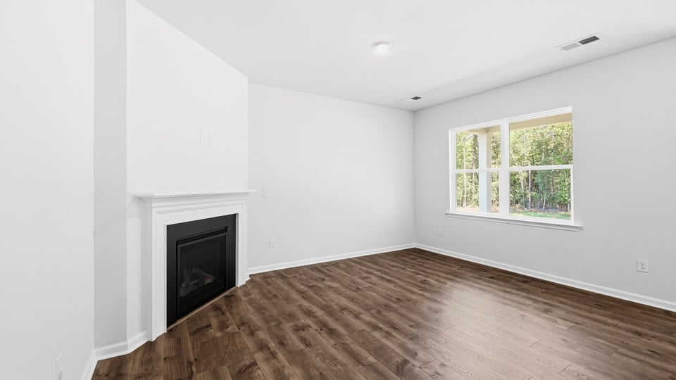 Living room with windows and fireplace.
