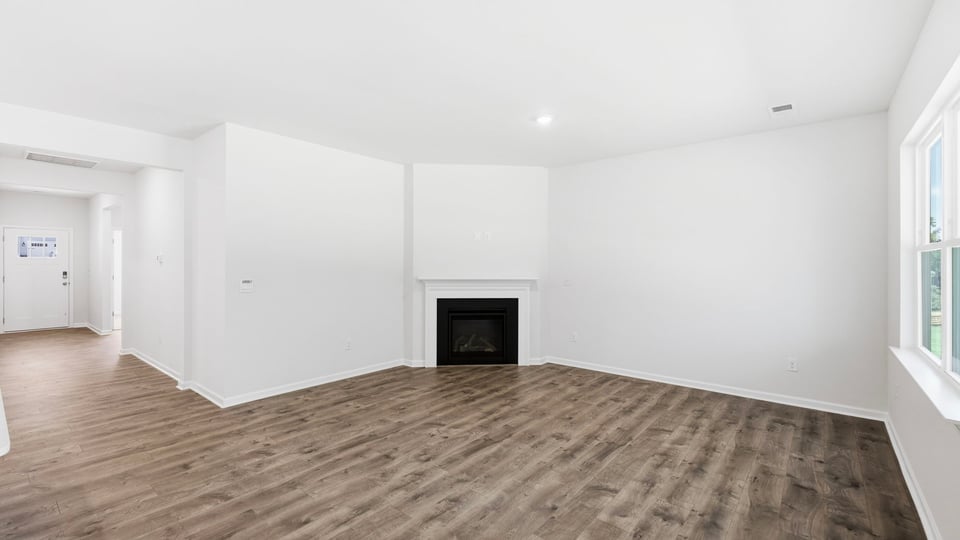 Living room with windows and fireplace.