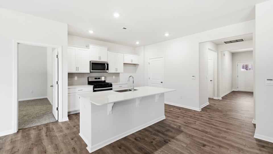 Kitchen and island with quartz countertops.