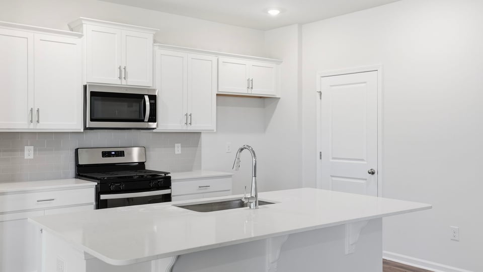 Kitchen and island with quartz countertops.