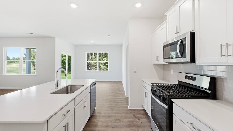 Kitchen and island with quartz countertops.