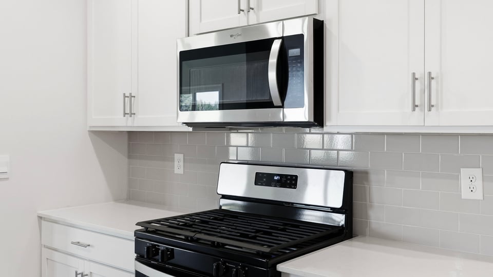Kitchen and island with quartz countertops.
