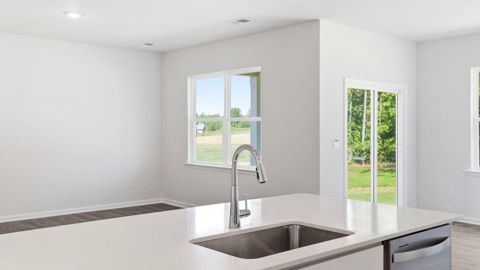 Kitchen and island with quartz countertops.
