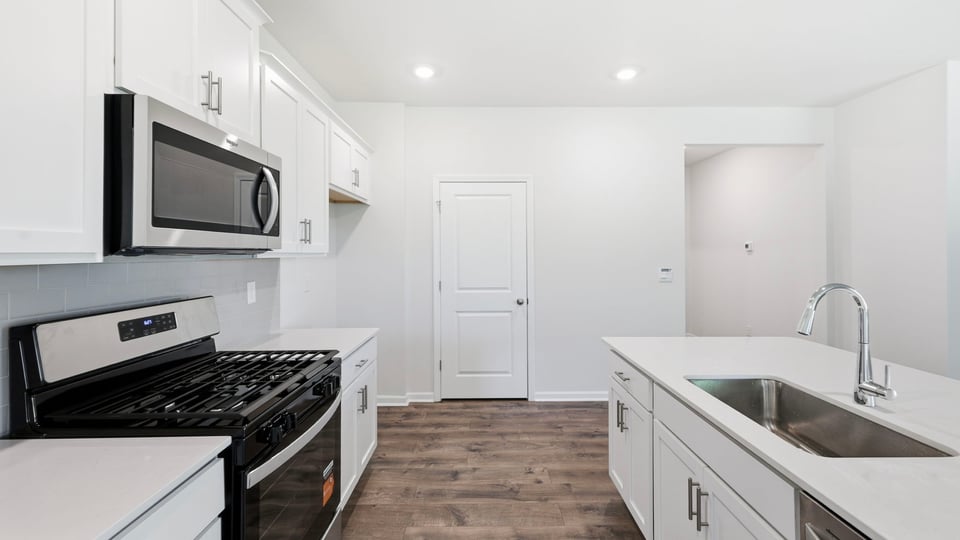 Kitchen and island with quartz countertops.