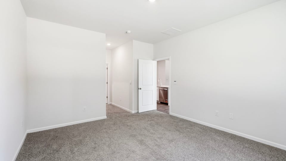 Bedroom with carpet and window.