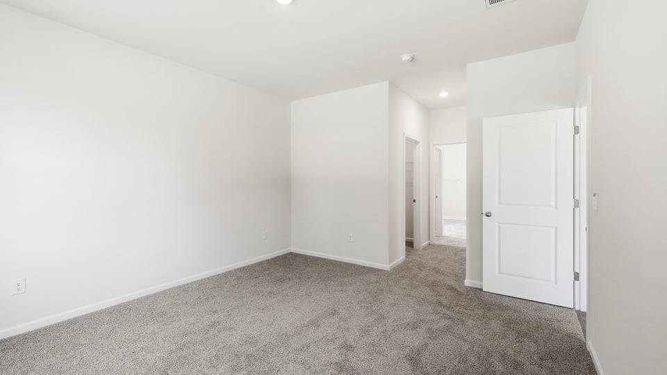 Bedroom with carpet and window.