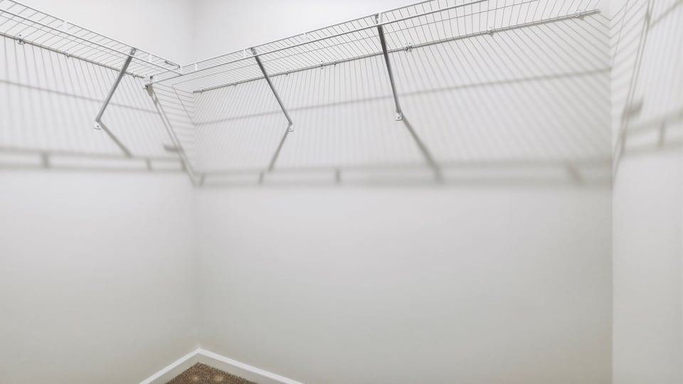 Closet with hanging storage racks.