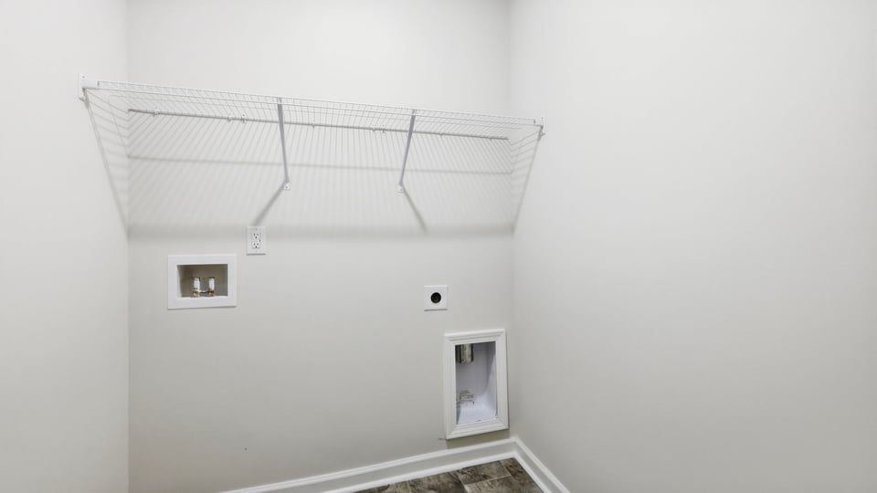 Laundry room with hanging storage racks.