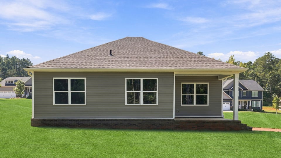 Back exterior of home with large backyard.