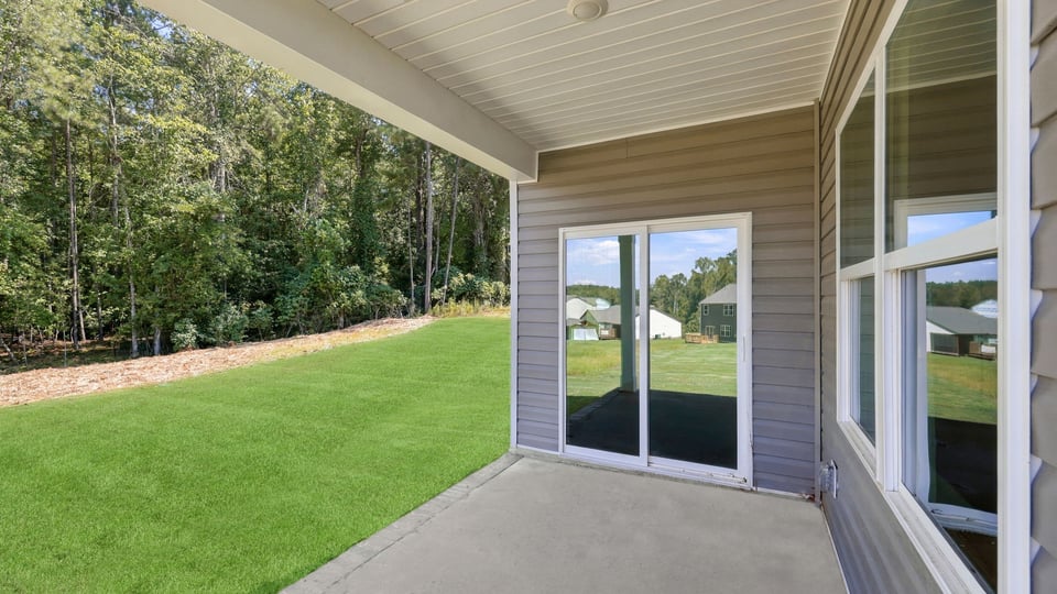 Back exterior of home with covered patio.