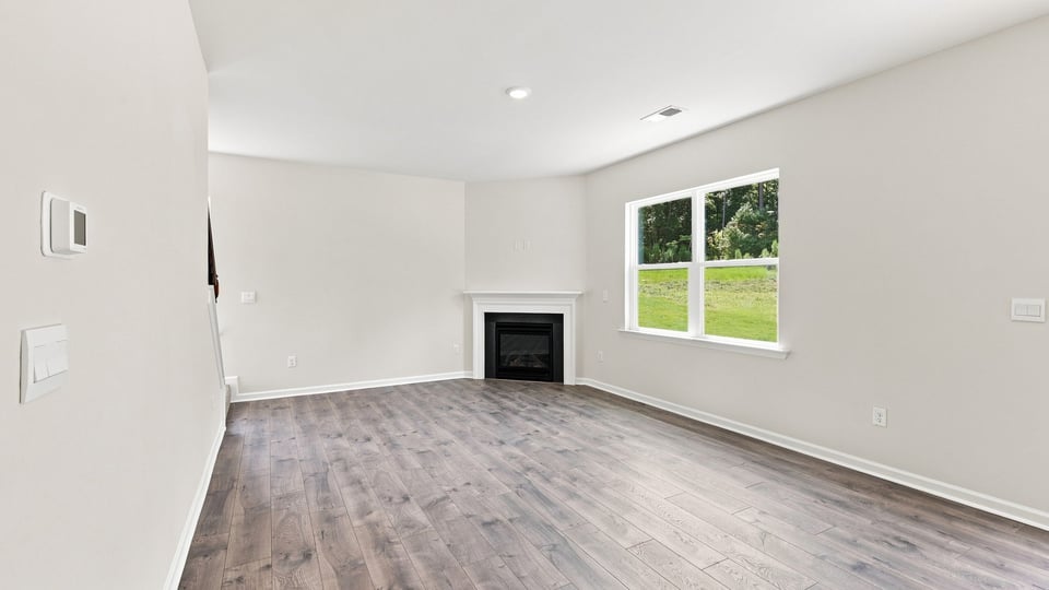 Living room with windows and fireplace.
