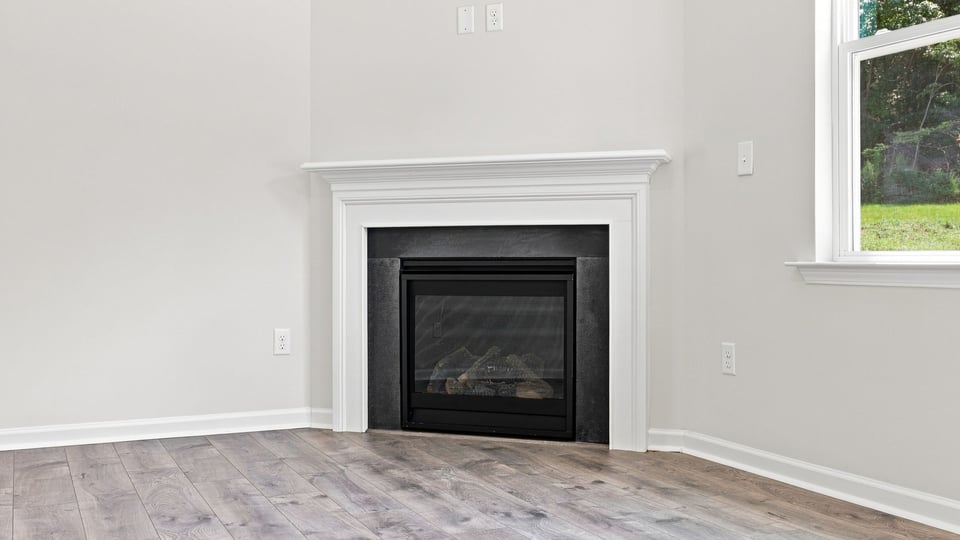 Living room with windows and fireplace.