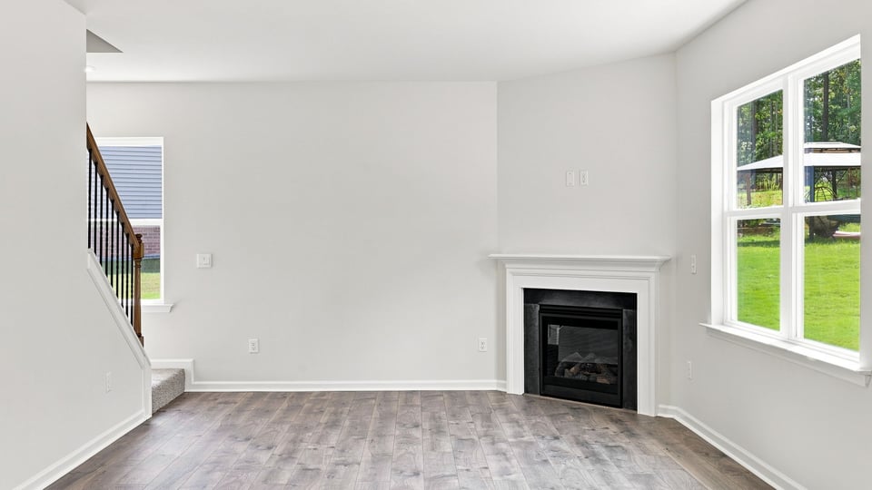 Living room with windows and fireplace.