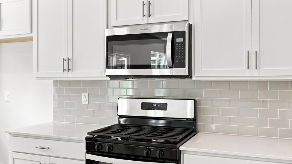 Kitchen and island with quartz countertops.
