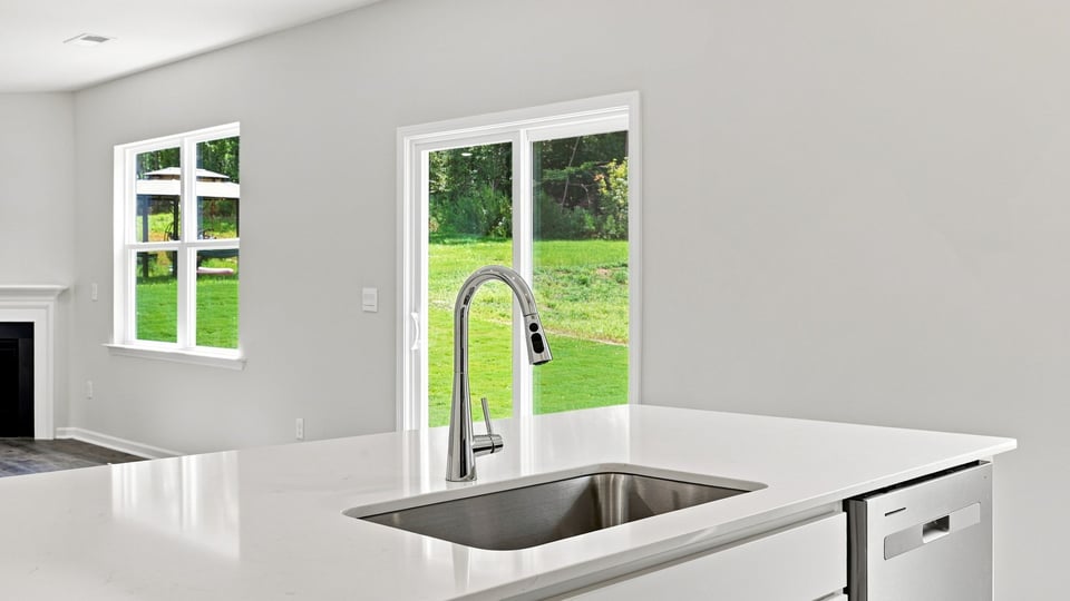 Kitchen and island with quartz countertops.