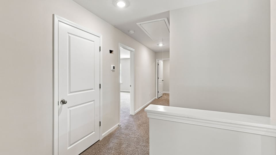 Loft area with carpet.