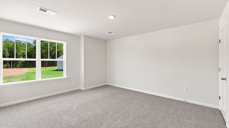 Bedroom with carpet and window.