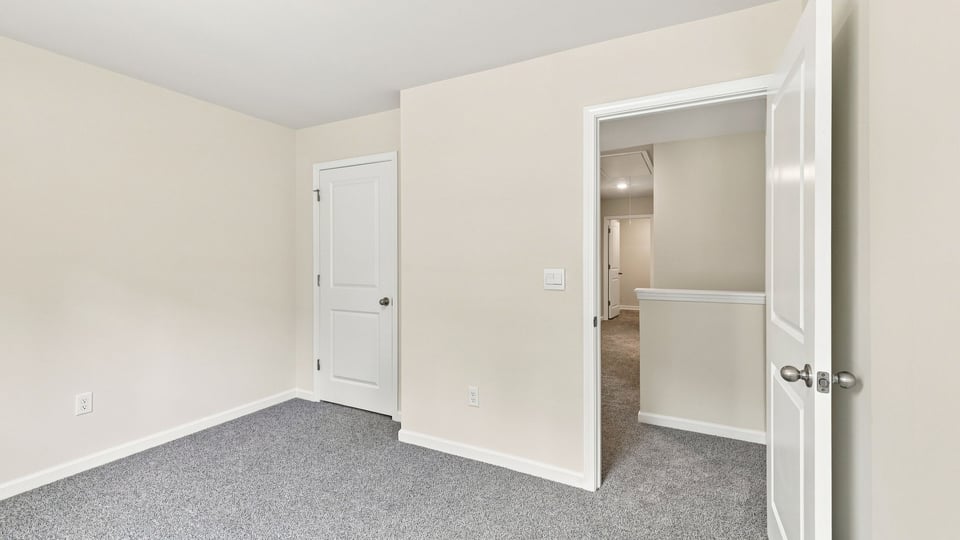 Bedroom with carpet and window.
