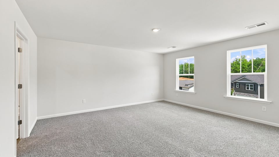 Bedroom with carpet and window.