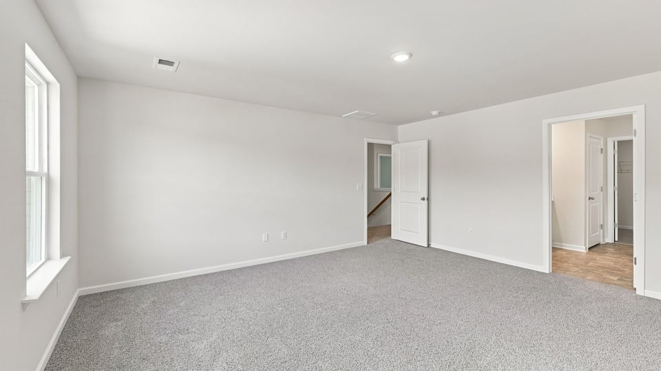 Bedroom with carpet and window.
