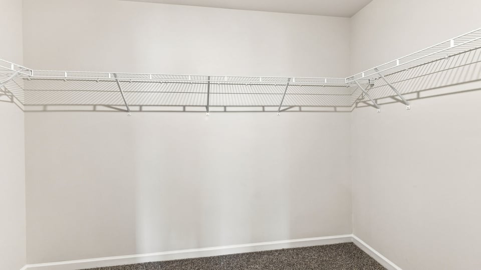 Closet with hanging storage racks.