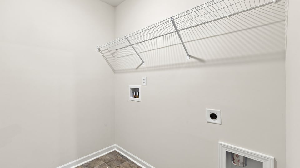 Laundry room with hanging storage racks.
