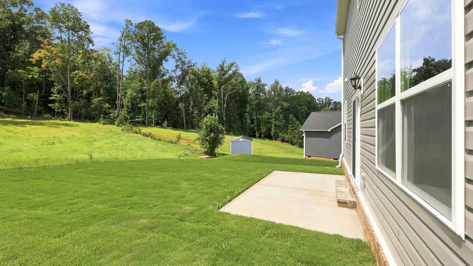 Back exterior of home with large backyard.