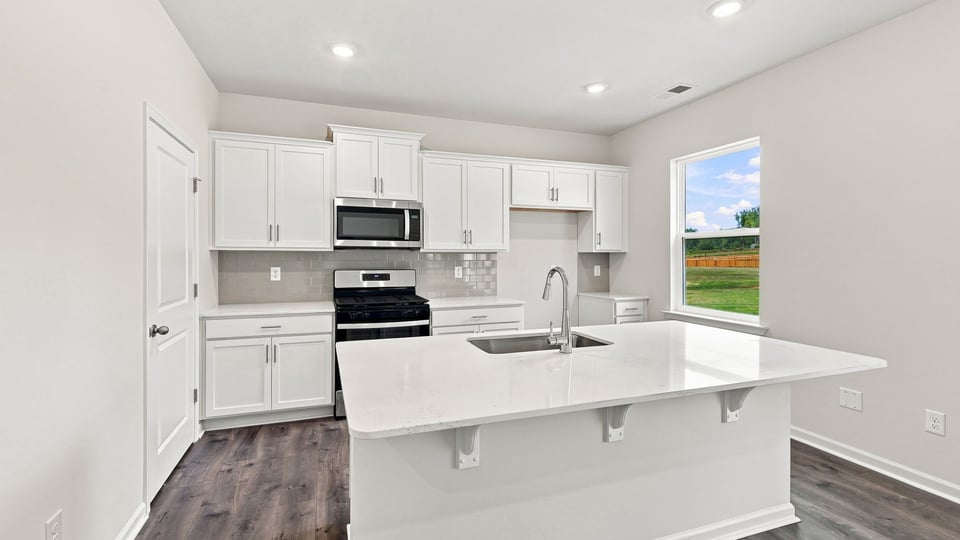 Kitchen with island and cabinets.