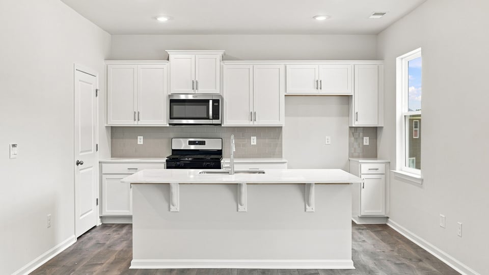 Kitchen with island and cabinets.