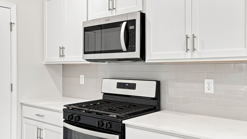 Kitchen with island and cabinets.